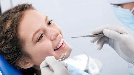 patient model receiving care from a dentist