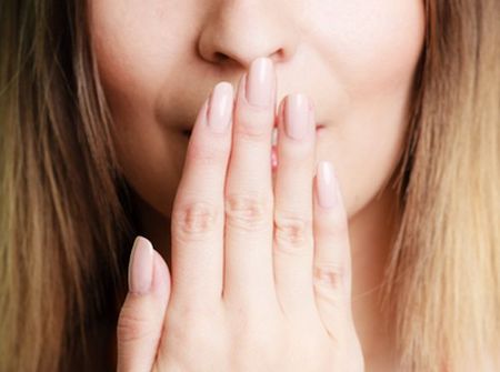 women hiding her mouth with her hands