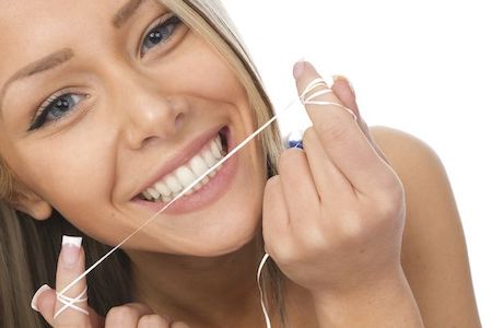 La Mesa dentist patient model flossing her teeth