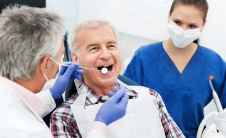 elderly dental patient model receiving dental care