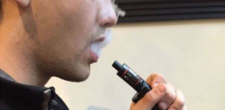 man smoking electronic cigarette