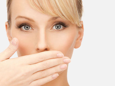 woman covering her mouth with her hand