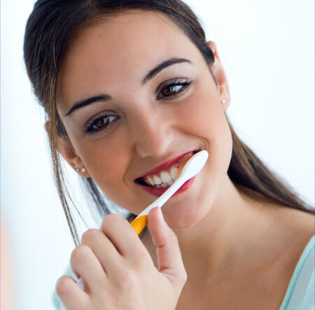 La Mesa dentist patient model brushing her teeth