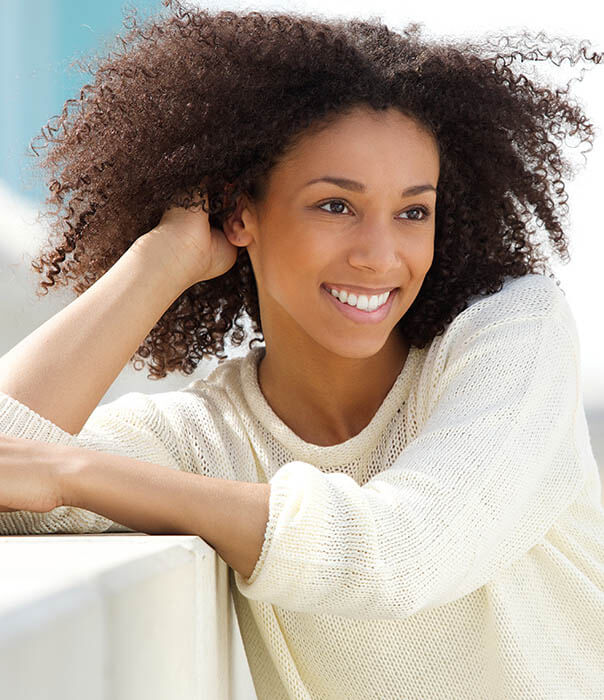 invisalign patient model smiling and running her fingers through her hair