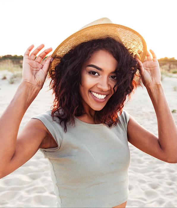 sleep apnea treatment patient model smiling wearing a sun hat