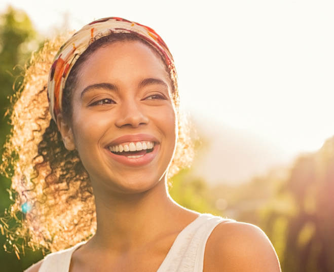 invisalign patient model wearing a headband and smiling