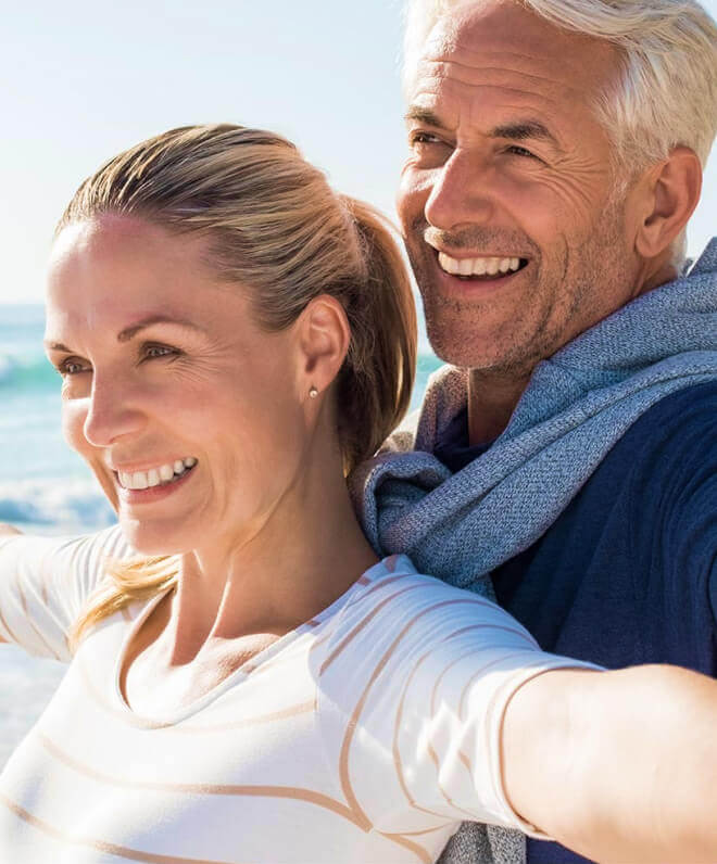 la mesa implant dentist patient models at the beach smiling